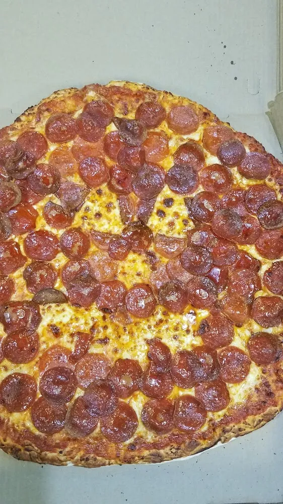Cheese and Pepperoni Pizza with Sweet Sauce Made into a Pumpkin for Halloween